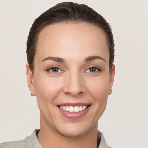 Joyful white young-adult female with short  brown hair and brown eyes