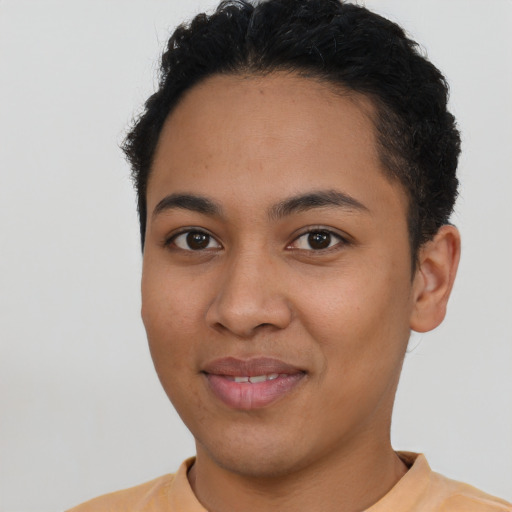 Joyful latino young-adult female with short  black hair and brown eyes