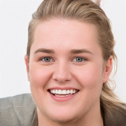 Joyful white young-adult female with long  brown hair and blue eyes