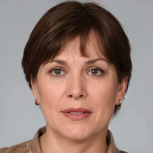 Joyful white adult female with medium  brown hair and brown eyes