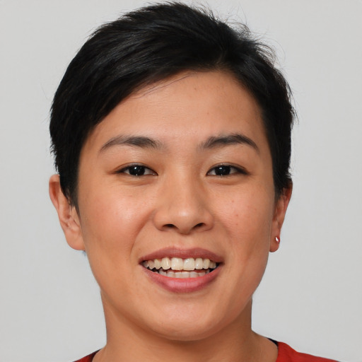 Joyful asian young-adult female with short  brown hair and brown eyes