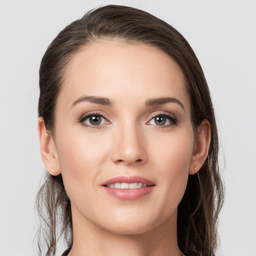 Joyful white young-adult female with long  brown hair and grey eyes