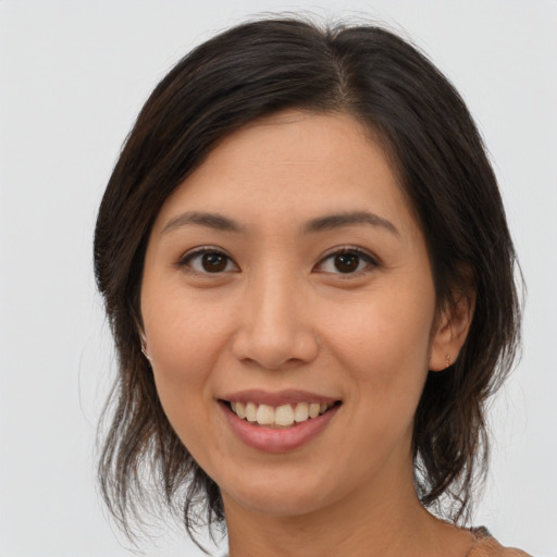 Joyful white young-adult female with medium  brown hair and brown eyes