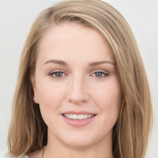 Joyful white young-adult female with long  brown hair and blue eyes