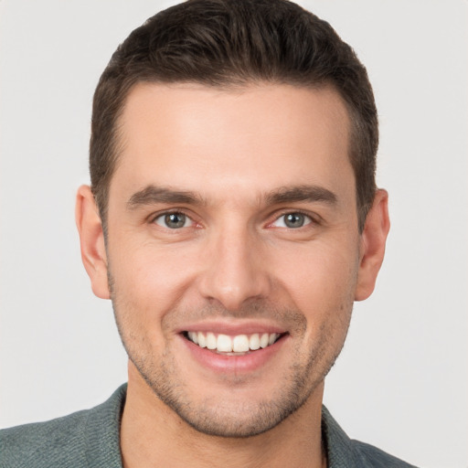 Joyful white young-adult male with short  brown hair and brown eyes