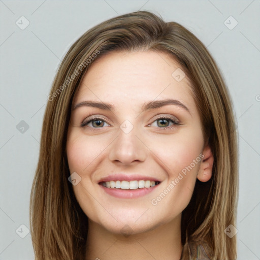 Joyful white young-adult female with long  brown hair and green eyes