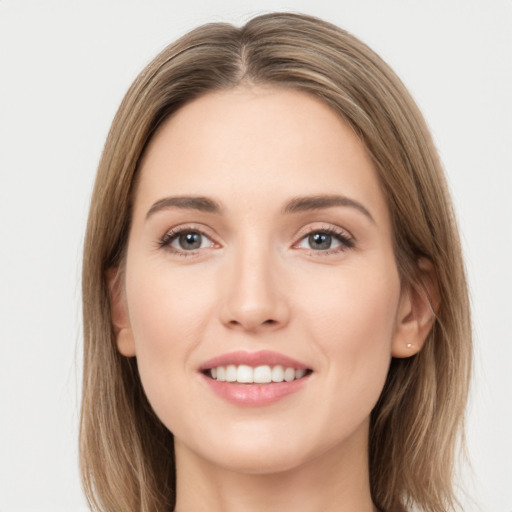 Joyful white young-adult female with long  brown hair and green eyes