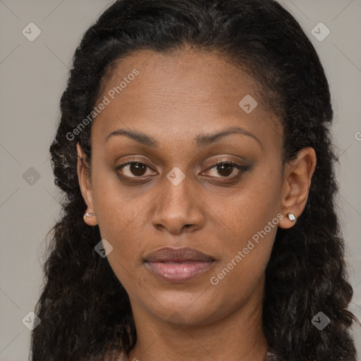 Joyful black young-adult female with long  brown hair and brown eyes