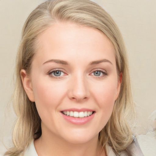 Joyful white young-adult female with medium  brown hair and blue eyes