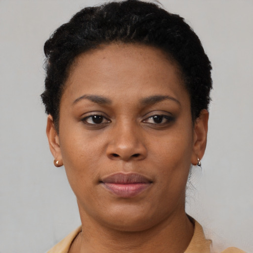 Joyful black young-adult female with short  brown hair and brown eyes