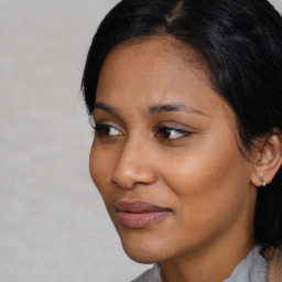 Joyful latino young-adult female with short  black hair and brown eyes