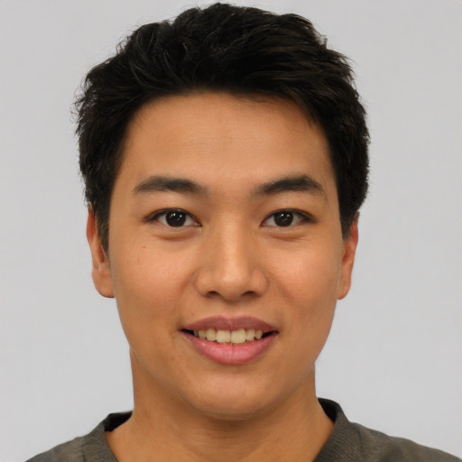 Joyful asian young-adult male with short  black hair and brown eyes