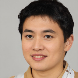 Joyful asian young-adult male with short  brown hair and brown eyes