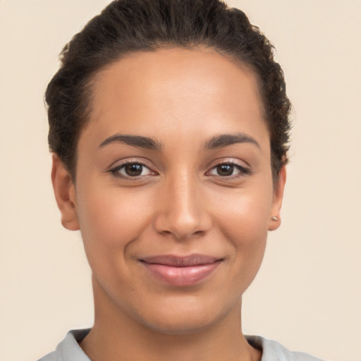 Joyful latino young-adult female with short  brown hair and brown eyes