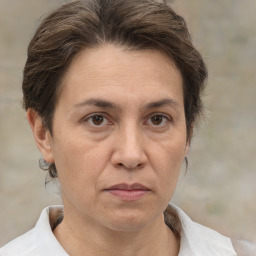 Joyful white adult female with short  brown hair and brown eyes