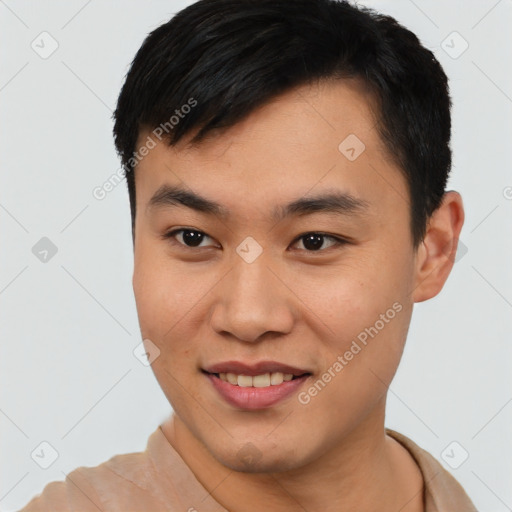 Joyful asian young-adult male with short  black hair and brown eyes