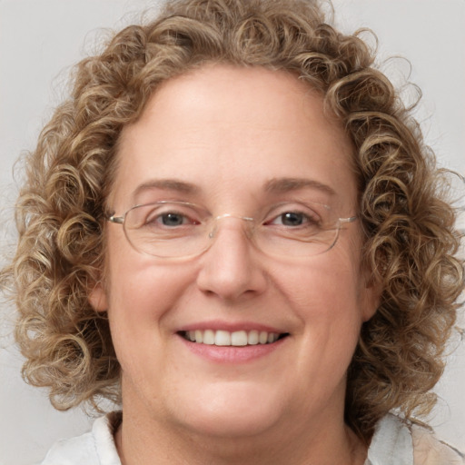 Joyful white adult female with medium  brown hair and blue eyes