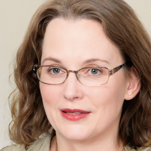 Joyful white adult female with medium  brown hair and blue eyes