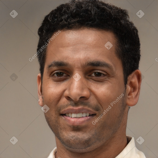 Joyful latino adult male with short  black hair and brown eyes