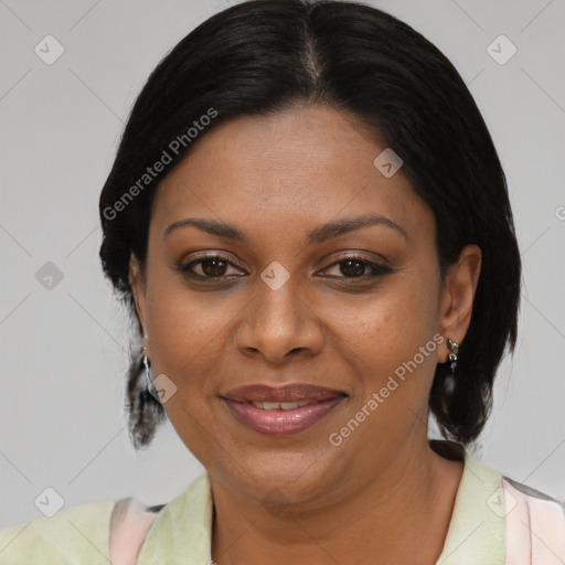 Joyful black adult female with medium  brown hair and brown eyes