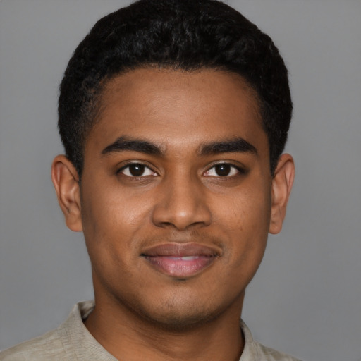 Joyful black young-adult male with short  black hair and brown eyes