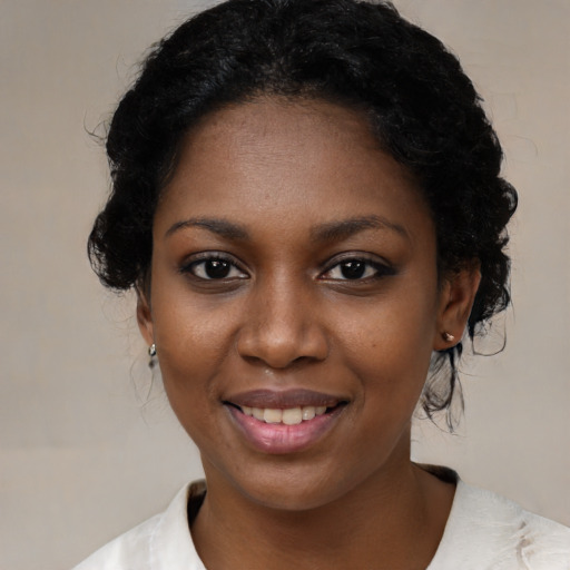 Joyful black young-adult female with medium  black hair and brown eyes