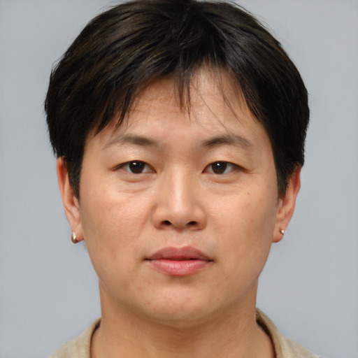 Joyful asian adult male with short  brown hair and brown eyes