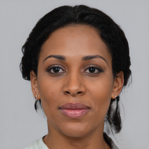 Joyful black adult female with medium  black hair and brown eyes
