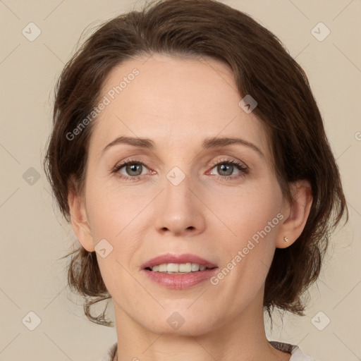 Joyful white adult female with medium  brown hair and green eyes