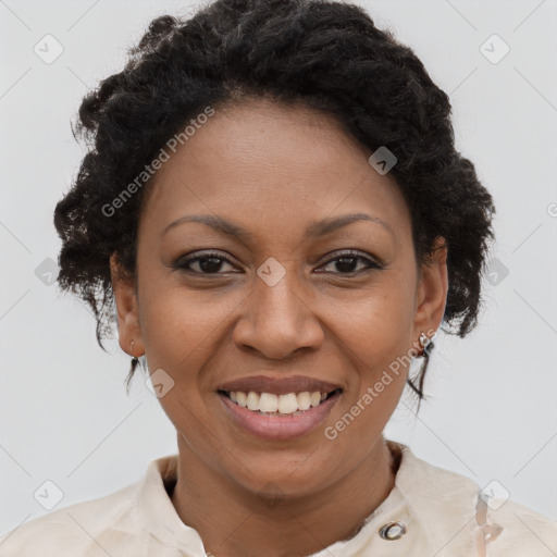 Joyful black adult female with short  brown hair and brown eyes