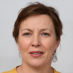 Joyful white adult female with medium  brown hair and grey eyes