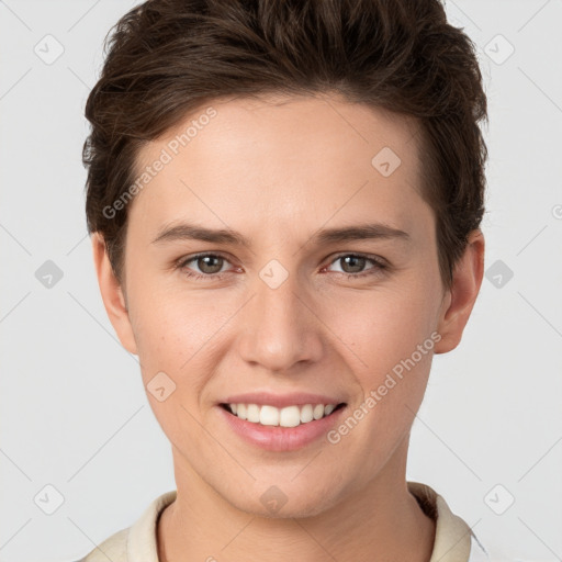 Joyful white young-adult female with short  brown hair and grey eyes