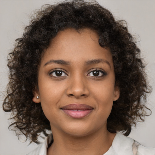 Joyful black young-adult female with medium  brown hair and brown eyes