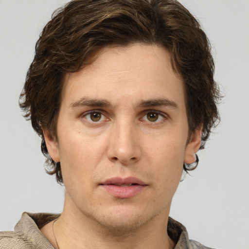 Joyful white adult male with short  brown hair and green eyes