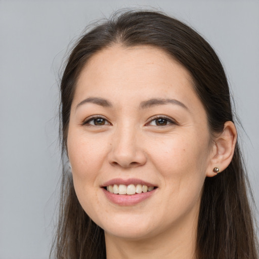 Joyful white young-adult female with long  brown hair and brown eyes