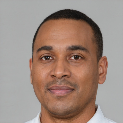 Neutral latino adult male with short  black hair and brown eyes