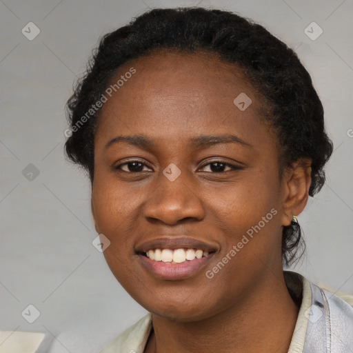 Joyful black young-adult female with short  black hair and brown eyes