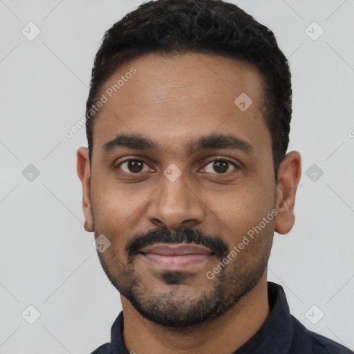 Joyful black young-adult male with short  black hair and brown eyes