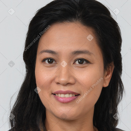 Joyful latino young-adult female with long  brown hair and brown eyes