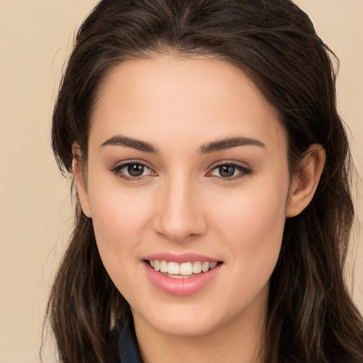 Joyful white young-adult female with long  brown hair and brown eyes