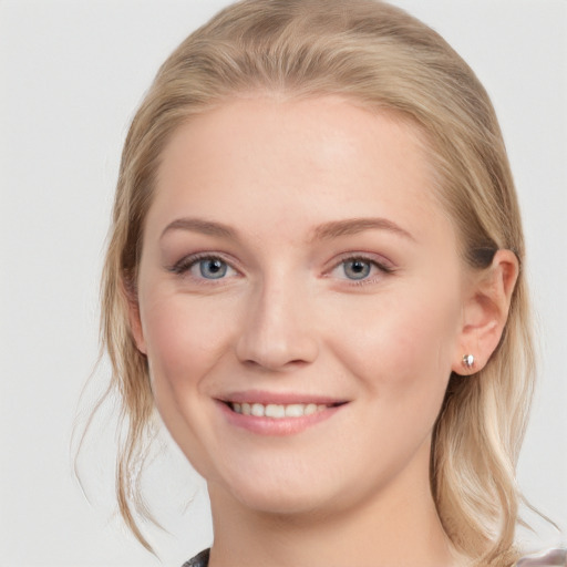 Joyful white young-adult female with medium  brown hair and blue eyes