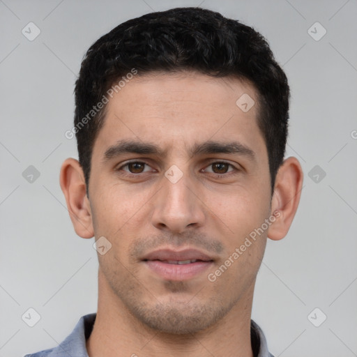 Joyful white young-adult male with short  black hair and brown eyes