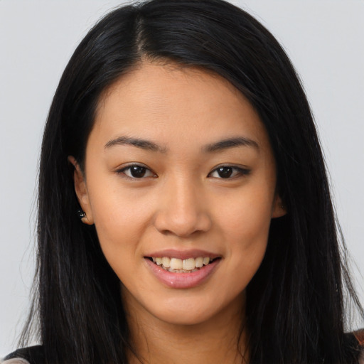 Joyful asian young-adult female with long  brown hair and brown eyes