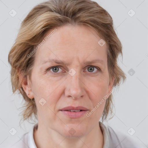 Joyful white adult female with medium  brown hair and blue eyes