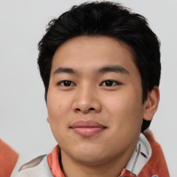 Joyful asian young-adult male with short  black hair and brown eyes