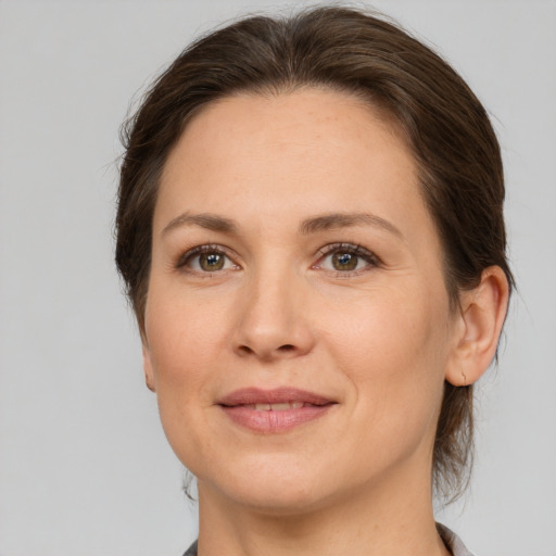 Joyful white adult female with medium  brown hair and brown eyes