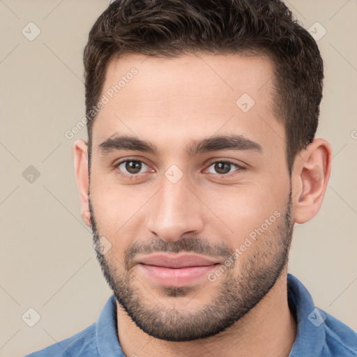 Joyful white young-adult male with short  brown hair and brown eyes