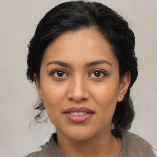 Joyful latino young-adult female with medium  black hair and brown eyes