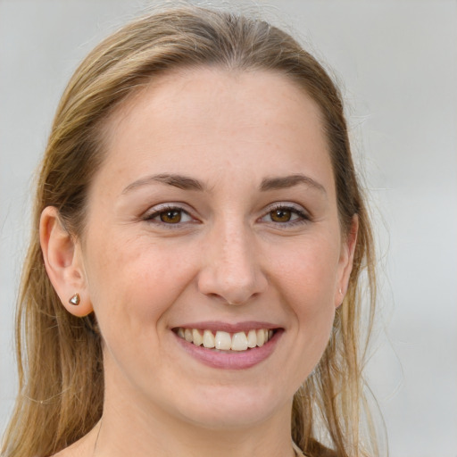 Joyful white young-adult female with long  brown hair and grey eyes