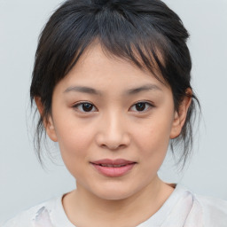 Joyful asian child female with medium  brown hair and brown eyes